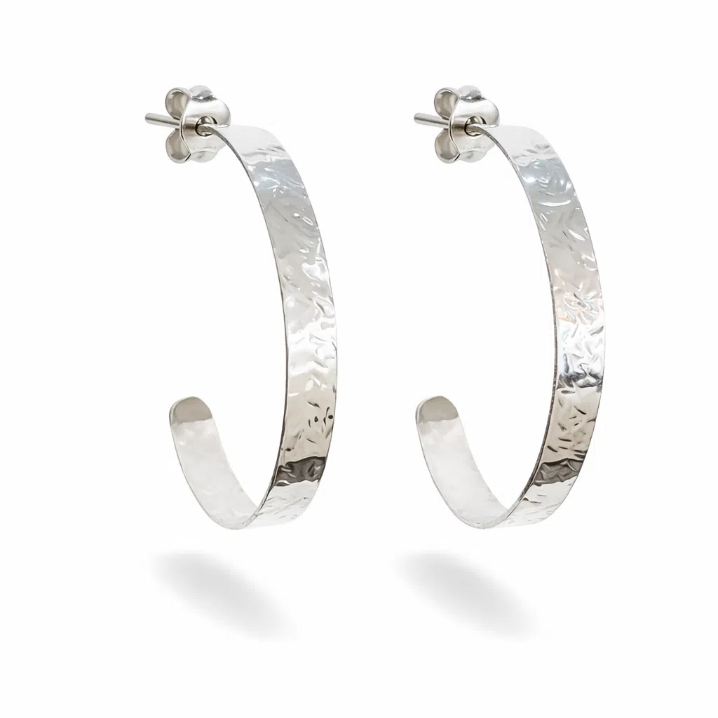 Tijdloze zilveren hamerslag creolen met handbewerkte textuur, glanzende afwerking en ambachtelijke uitstraling